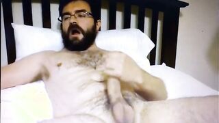 Watch this hung dude with a bear tattoo tease and tug on a lollipop with his hands suspended in the air