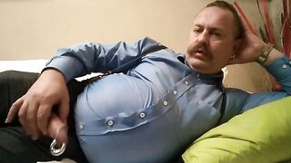 Horny bear with a big moustache gives a steamy handjob and takes a cumshot
