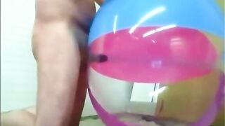 Watch this hairy dude stroke his toy to a massive beach ball and fill it up with his own jizz