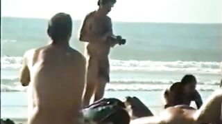 Amateur babe gets a hairy big cock on the beach and gives a wild handjob