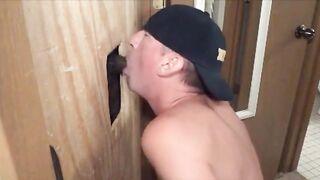 Hairy black stud slurps on a big black cock at the glory hole