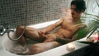 Hairy guy with tattoos jerks off in bathtub until he cums hard